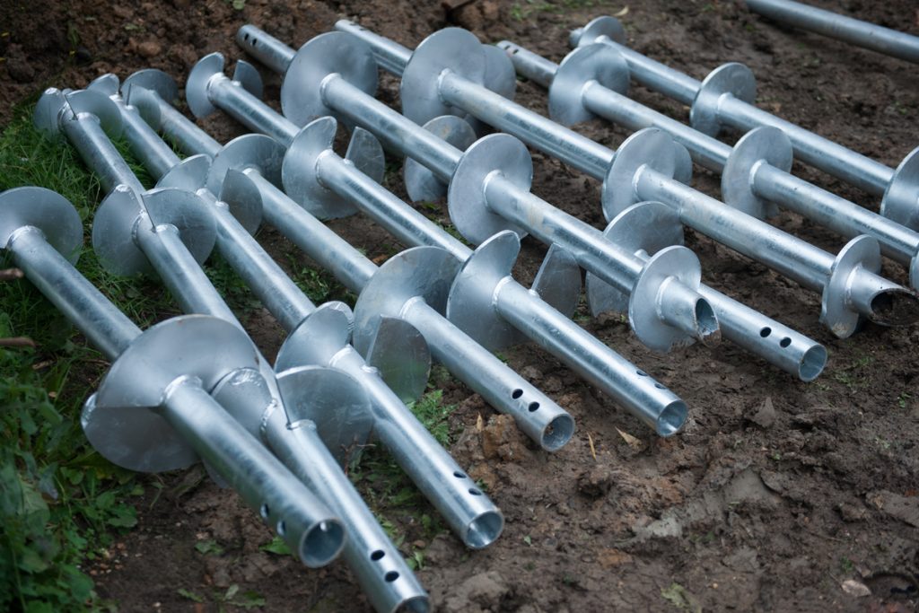 Helical anchors used to support mining and extraction structures