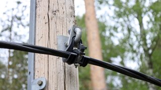 Cable suspension clamps supporting overhead cables