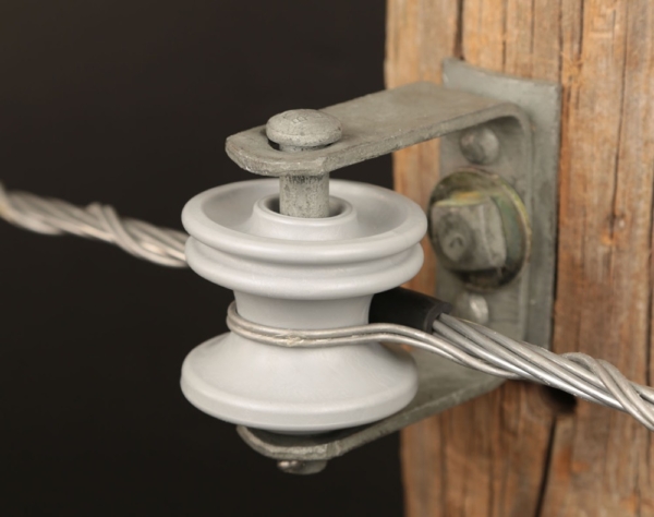 Spool insulators isolate and support conductors