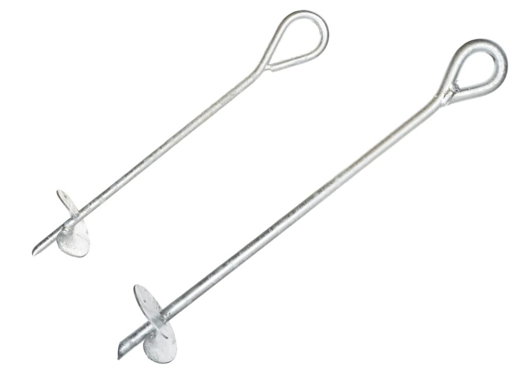 Helical anchors secure guy wires supporting wind turbines